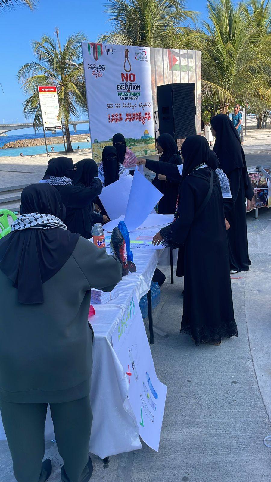نساء في وقفه تضامنيه يرفعن علم فلسطين